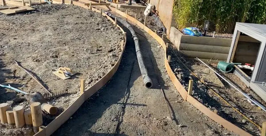 Laying the piping of the pond